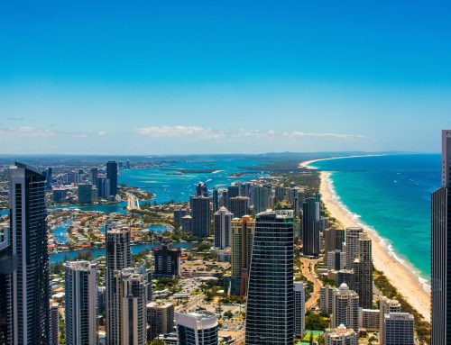 Aerial view of the Gold Coast showcasing a vibrant skyline, coastal beaches, and blue waters, reflecting the luxurious lifestyle and home design potential in the region.